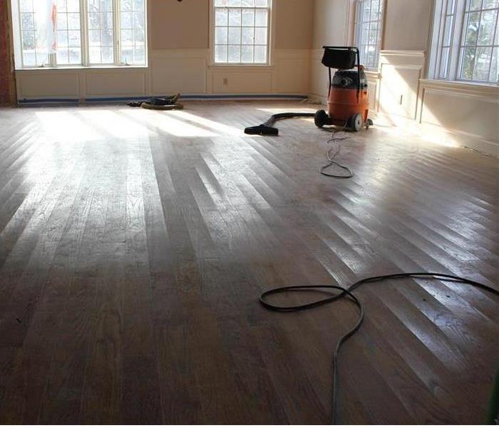 industrial wet/vac removing remaining water from the hardwood floorboards
