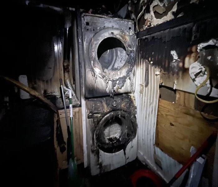 Badly Burned utility room area showing a completely burned washer and dryer