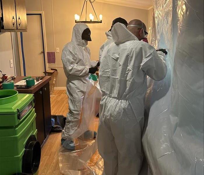 SERVPRO experts in PPE sealing off mold contaminated areas and preparing remediation steps